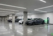 EV charging for apartments 2026 underground parking garage with electric vehicle plugged in