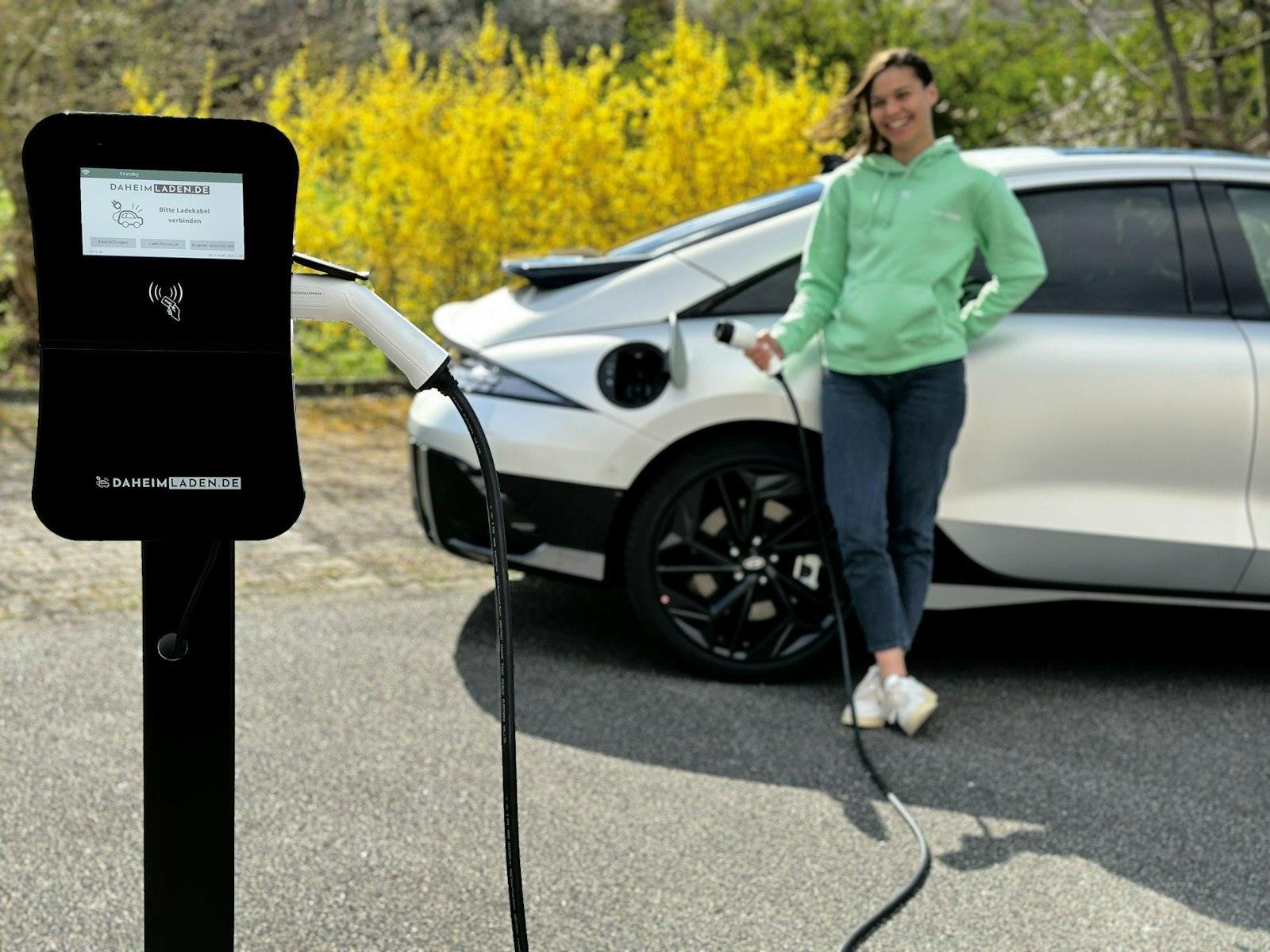 Person plugging in EV at charging station