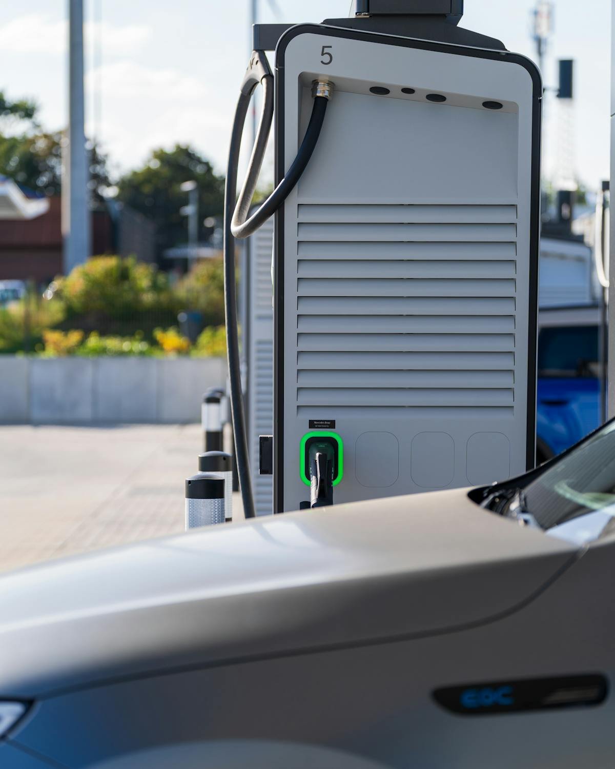 Electric vehicle charging at modern outdoor station showcasing eco-friendly technology